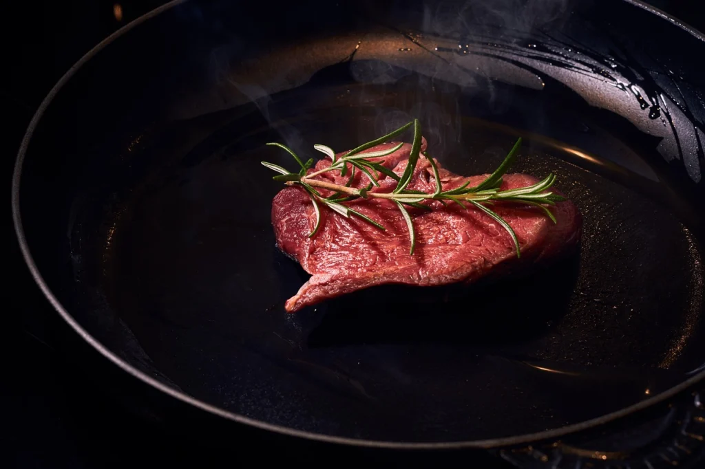 Searing beef cubes in small batches in a cast iron skillet for stew